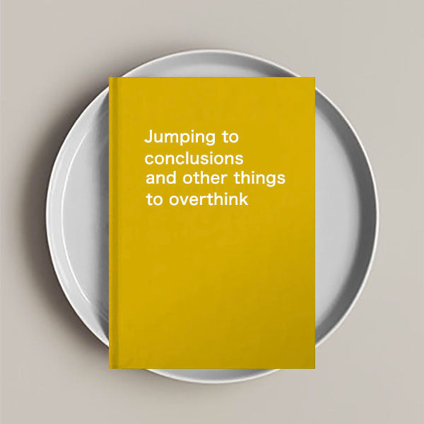 Journal notebook with the phrase 'Jumping to conclusions and other things to overthink' on the cover