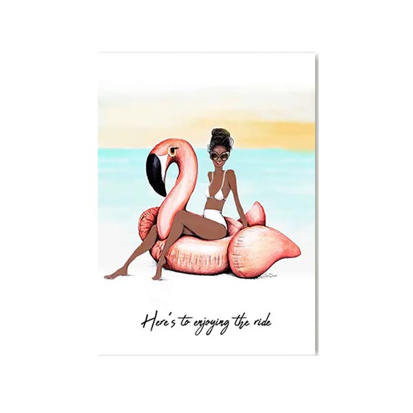 Greeting card with woman sitting on a pink flamingo float and the text "here's to enjoying the ride'