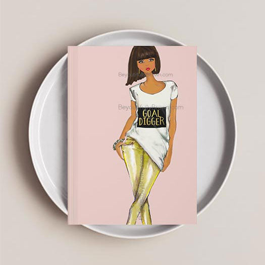 Journal notebook with an illustration of a woman wearing a 'Goal Digger' shirt on the cover