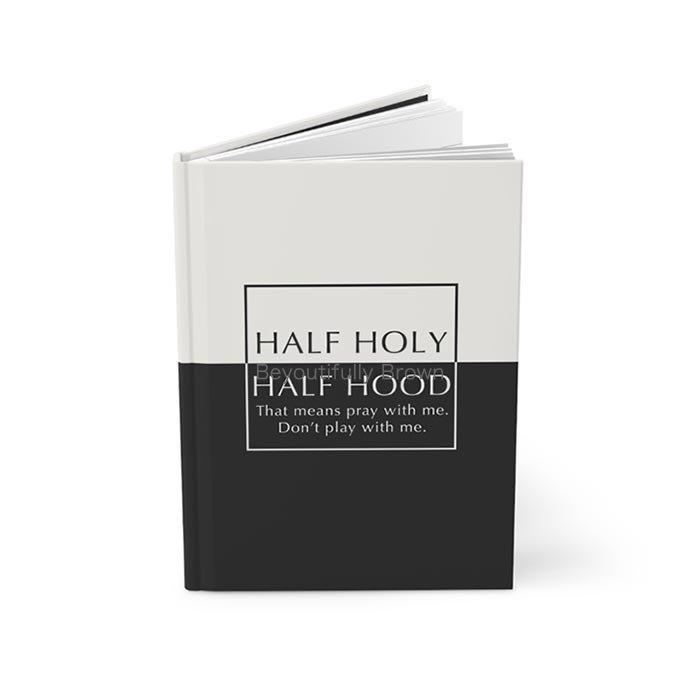 Journal notebook with text 'HALF HOLY HALF HOOD' on the cover