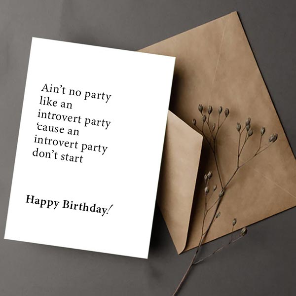 Birthday card for an introvert with humorous text and an envelope on a dark background