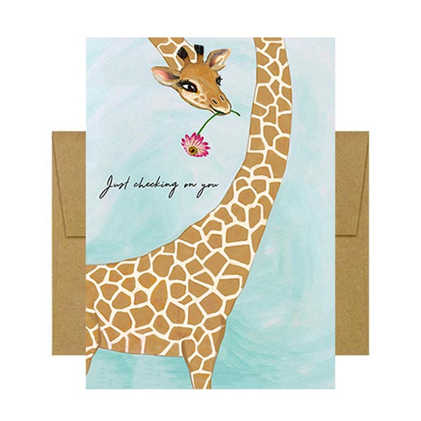 Greeting card with a giraffe illustration and 'Just checking on you' text on the cover
